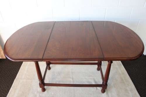 A wonderful solid teak "drop-leaf" table w/ side panels, very compact and perfect for limited space