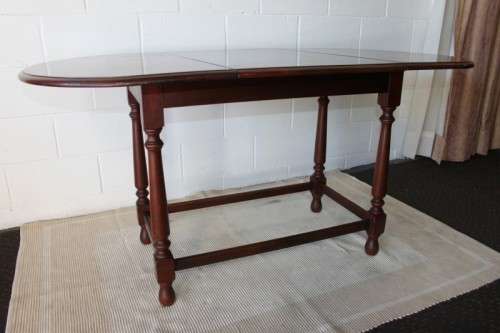 A wonderful solid teak "drop-leaf" table w/ side panels, very compact and perfect for limited space