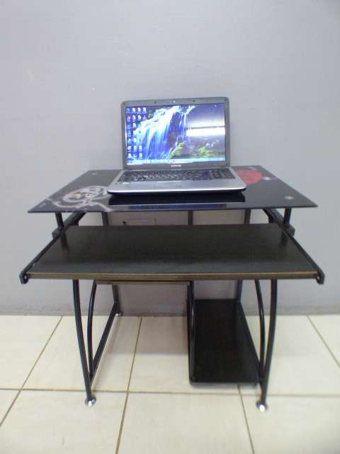 A lovely glass top writing/computer desk in good condition. Lovely in a ladies room.