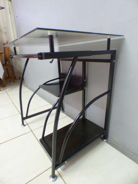 A lovely glass top writing/computer desk in good condition. Lovely in a ladies room.