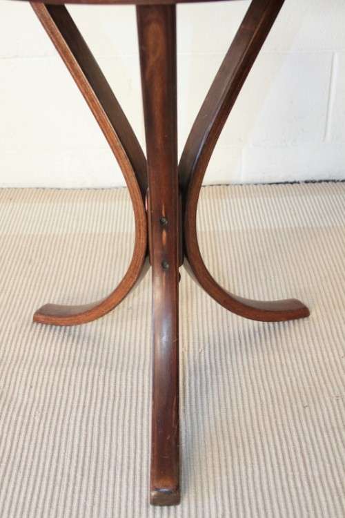 A stunning wicker-top occasional table with bentwood legs, something different in your home
