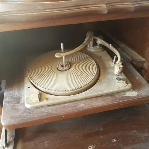 A vintage curved glass ball & claw radiogram display cabinet w/ original components for restoration