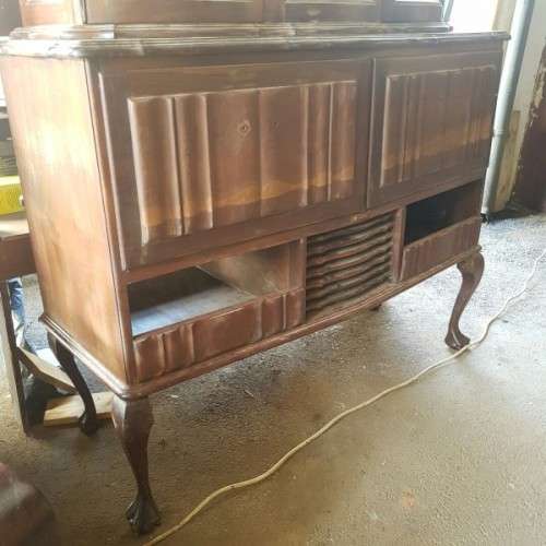 A vintage curved glass ball & claw radiogram display cabinet w/ original components for restoration