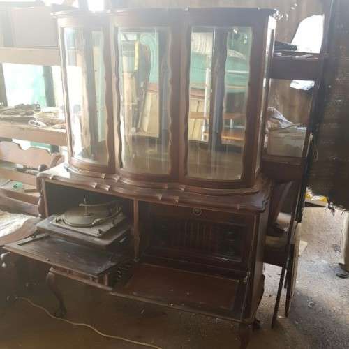 A vintage curved glass ball & claw radiogram display cabinet w/ original components for restoration