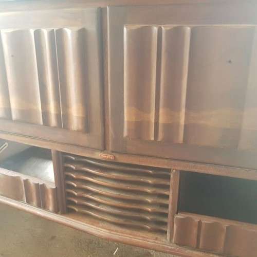 A vintage curved glass ball & claw radiogram display cabinet w/ original components for restoration