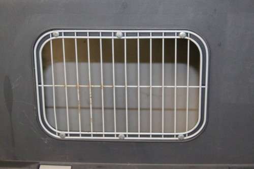 A large pet kennel/ travel case with two storage compartments on top