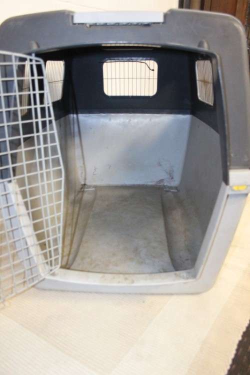 A large pet kennel/ travel case with two storage compartments on top