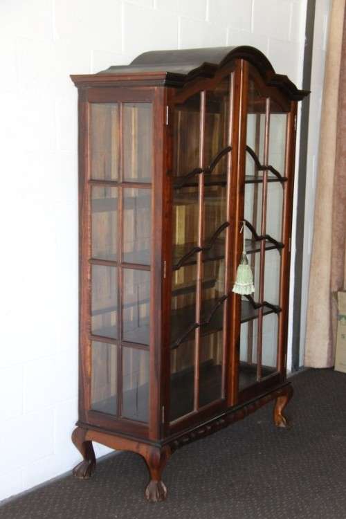 An incredible solid Stinkwood "gabled" display cabinet w/ large cottage pane doors & loads of space