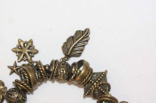 **RS17** A "chunky" ladies elasticised metal-beaded charm bracelet with an array of charms