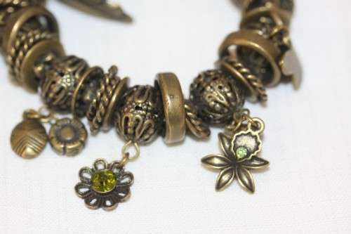 **RS17** A "chunky" ladies elasticised metal-beaded charm bracelet with an array of charms