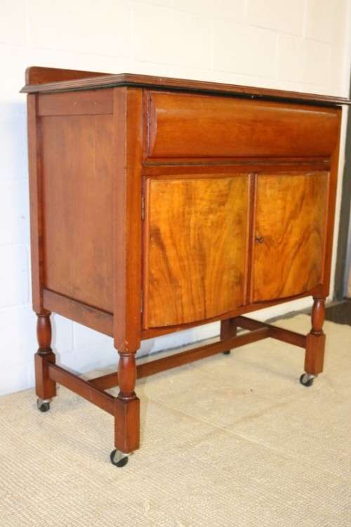 A remarkable Art Deco oak drinks cabinet with fall down counter and spacious cupboards