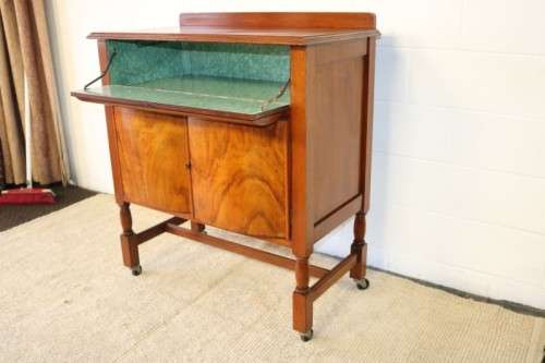 A remarkable Art Deco oak drinks cabinet with fall down counter and spacious cupboards