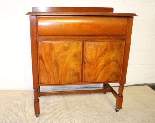 A remarkable Art Deco oak drinks cabinet with fall down counter and spacious cupboards