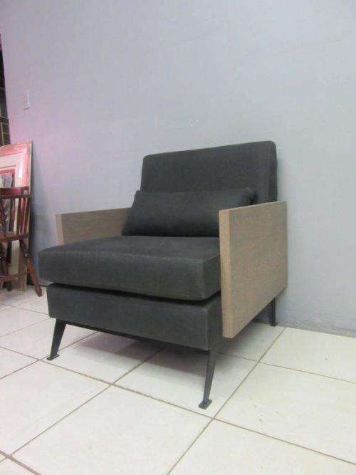 An absolutely gorgeous single seater sofa chair with futon and clean, stylish lines and wooden sides