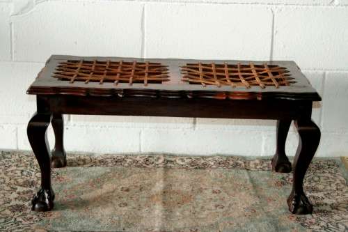 A stunning and well-made vintage solid imbuia ball & claw riempie foot stool with leather riempies