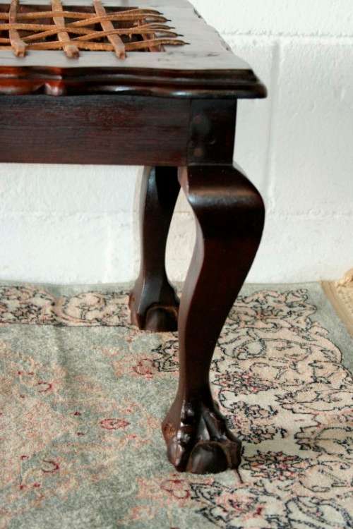 A stunning and well-made vintage solid imbuia ball & claw riempie foot stool with leather riempies