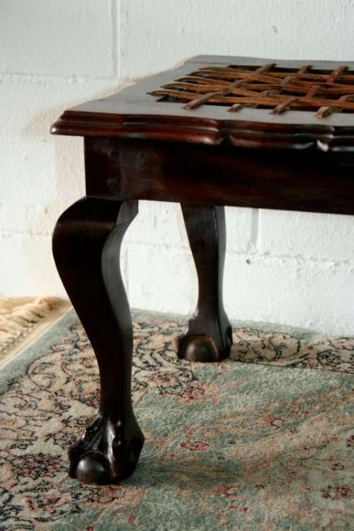 A stunning and well-made vintage solid imbuia ball & claw riempie foot stool with leather riempies