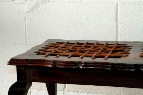 A stunning and well-made vintage solid imbuia ball & claw riempie foot stool with leather riempies