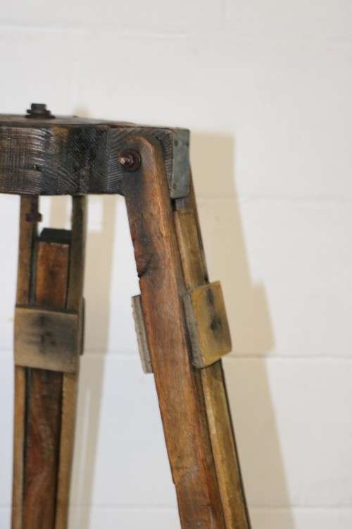 A fantastic antique metal and wood surveyor tripod in good condition for its impressive age