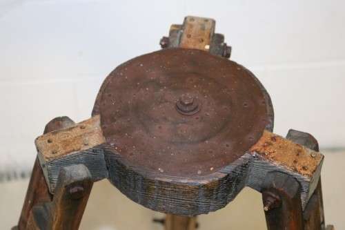 A fantastic antique metal and wood surveyor tripod in good condition for its impressive age