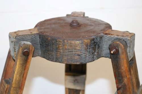 A fantastic antique metal and wood surveyor tripod in good condition for its impressive age