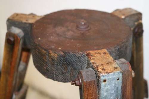 A fantastic antique metal and wood surveyor tripod in good condition for its impressive age