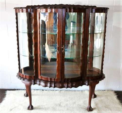 A beautiful vintage "curved glass" ball and claw display cabinet w scalloped edges & glass shelves
