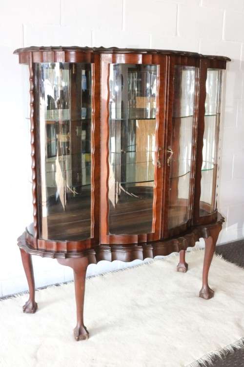 A beautiful vintage "curved glass" ball and claw display cabinet w scalloped edges & glass shelves