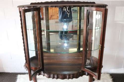 A beautiful vintage "curved glass" ball and claw display cabinet w scalloped edges & glass shelves