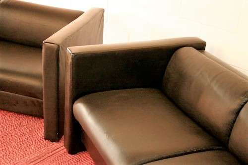 An awesome and stylish black bonded leather 2-seater "Tuxedo" couch in great condition