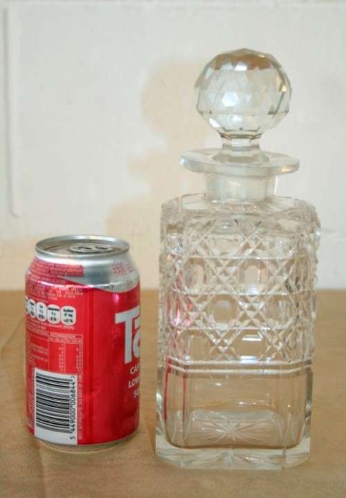 A beautiful classic ornate lead cut-crystal whiskey/ brandy decanter with a cut-crystal stopper