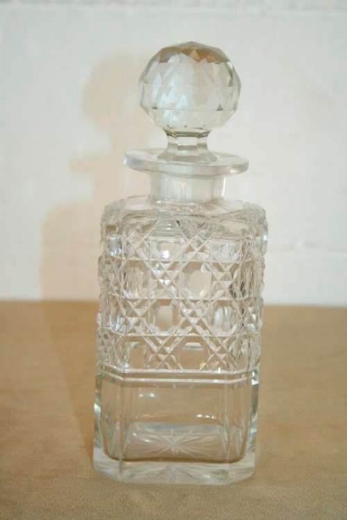A beautiful classic ornate lead cut-crystal whiskey/ brandy decanter with a cut-crystal stopper