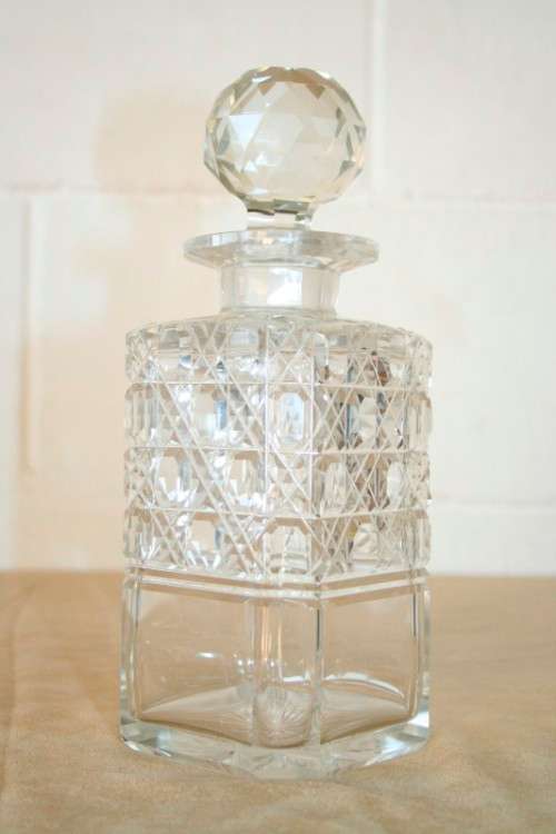 A beautiful classic ornate lead cut-crystal whiskey/ brandy decanter with a cut-crystal stopper