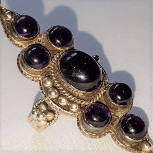 A truly spectacular Art Nouveau styled ladies ring with an array of beautiful round Amethyst stones