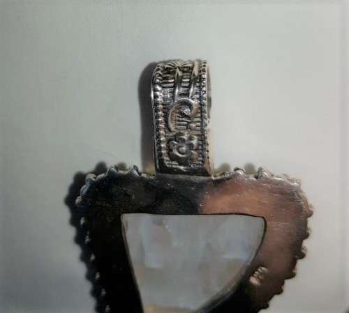 A stunning antique sterling silver pendant with a large clear Topaz and smokey Amethyst stones