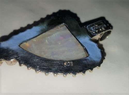 A stunning antique sterling silver pendant with a large clear Topaz and smokey Amethyst stones