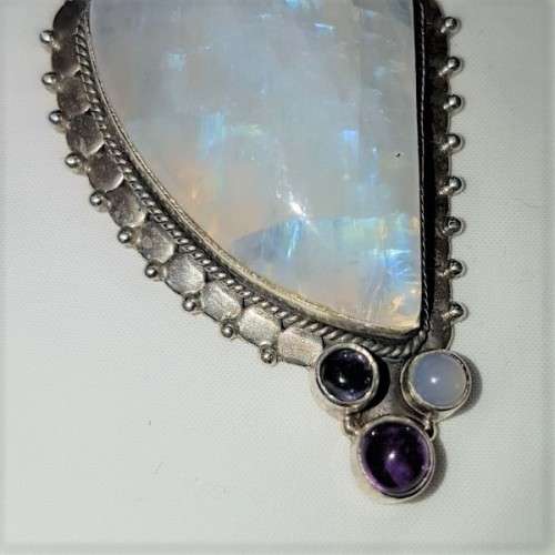 A stunning antique sterling silver pendant with a large clear Topaz and smokey Amethyst stones