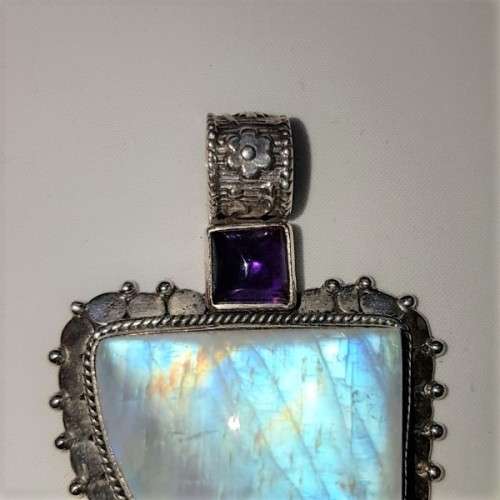 A stunning antique sterling silver pendant with a large clear Topaz and smokey Amethyst stones