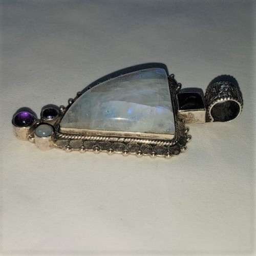 A stunning antique sterling silver pendant with a large clear Topaz and smokey Amethyst stones