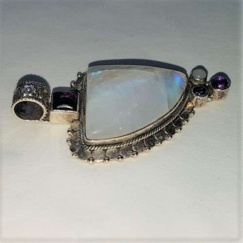 A stunning antique sterling silver pendant with a large clear Topaz and smokey Amethyst stones