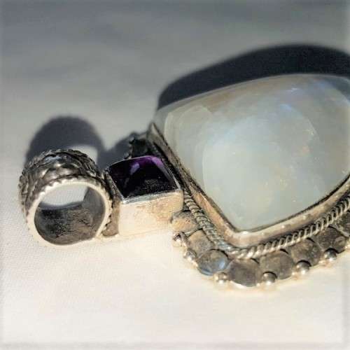 A stunning antique sterling silver pendant with a large clear Topaz and smokey Amethyst stones
