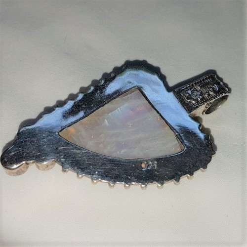 A stunning antique sterling silver pendant with a large clear Topaz and smokey Amethyst stones