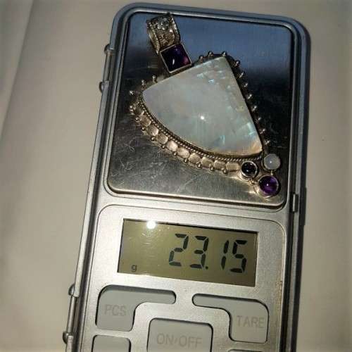 A stunning antique sterling silver pendant with a large clear Topaz and smokey Amethyst stones