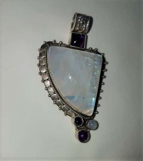 A stunning antique sterling silver pendant with a large clear Topaz and smokey Amethyst stones