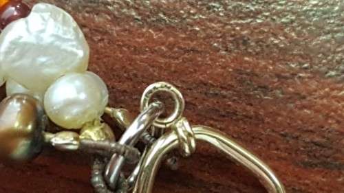 **RS17** A 3-strand multi-coloured pearl and beaded necklace with a 14ct yellow gold T-clasp