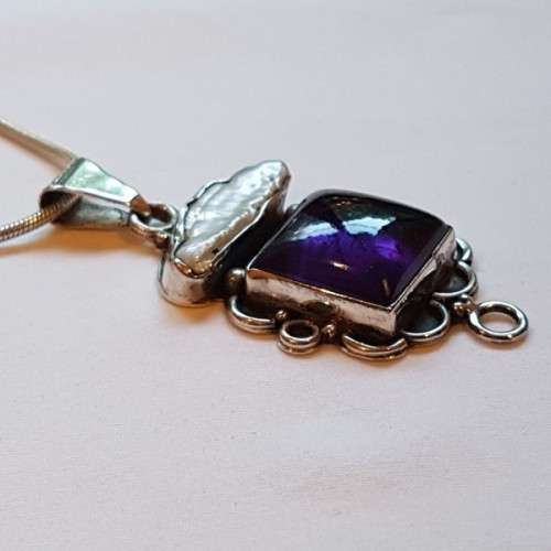 A beautiful sterling silver pendant w/ a large square Amethyst stone & baroque pearl on a chain