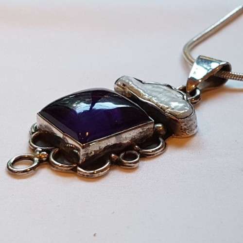 A beautiful sterling silver pendant w/ a large square Amethyst stone & baroque pearl on a chain