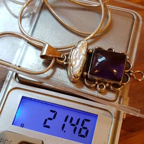 A beautiful sterling silver pendant w/ a large square Amethyst stone & baroque pearl on a chain