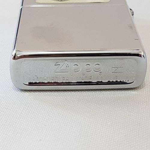 A fantastic polished chrome engraved "Girl with Harley Tattoo" Zippo lighter in box