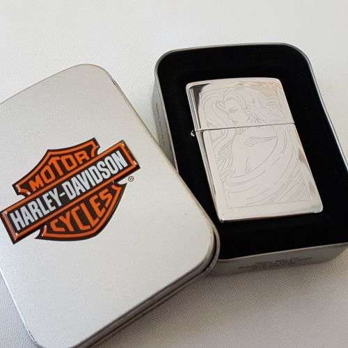 A fantastic polished chrome engraved "Girl with Harley Tattoo" Zippo lighter in box